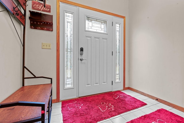 entrance foyer featuring light tile patterned floors and baseboards