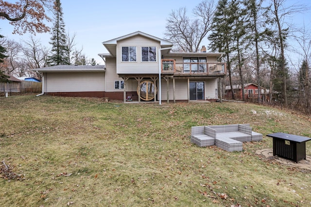 rear view of house featuring a lawn, a deck, and fence