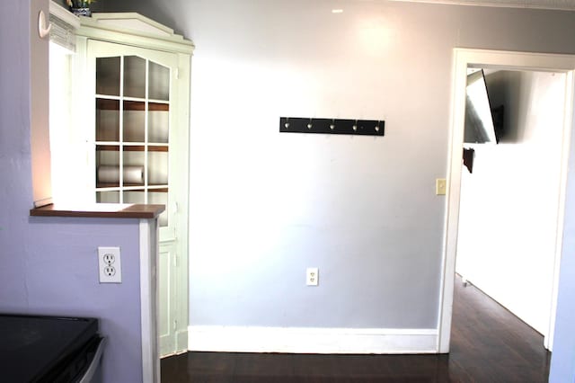 interior space with baseboards and wood finished floors