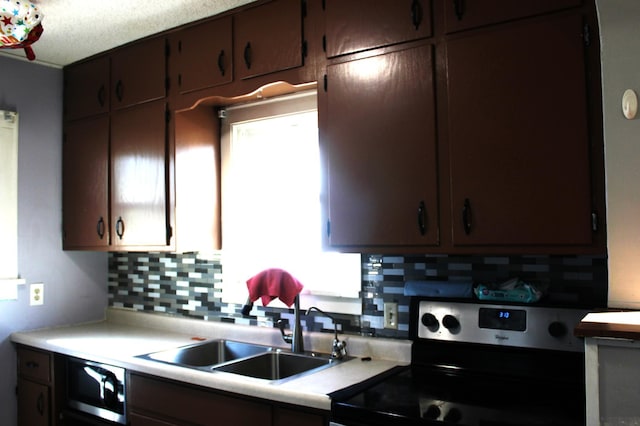 kitchen featuring dark brown cabinets, backsplash, light countertops, electric stove, and a sink