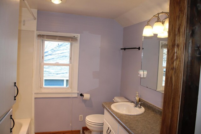 full bathroom featuring a bath, toilet, vanity, and vaulted ceiling