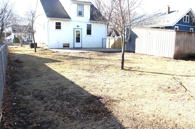 back of property featuring a patio area, stucco siding, a fenced backyard, and roof with shingles