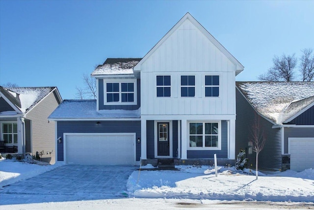 view of front of property featuring an attached garage, driveway, and board and batten siding