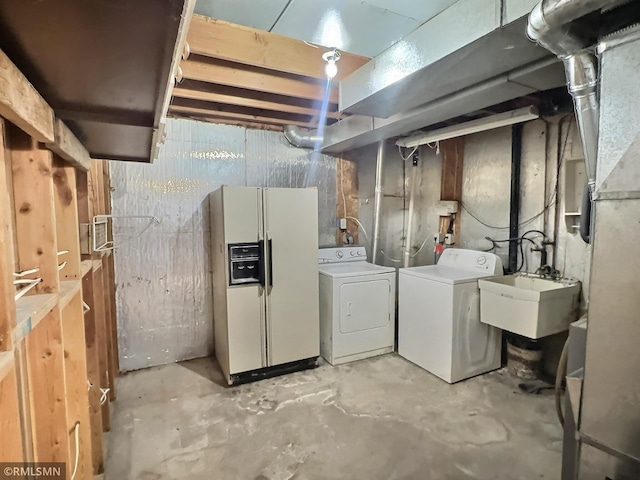 unfinished basement featuring a sink, separate washer and dryer, and white fridge with ice dispenser