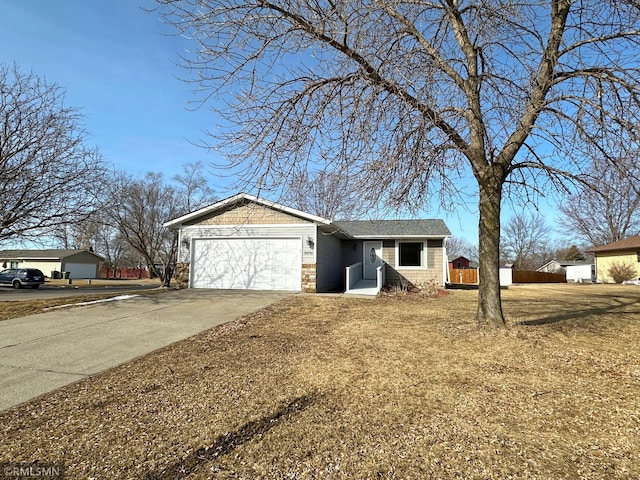 ranch-style home with concrete driveway and an attached garage