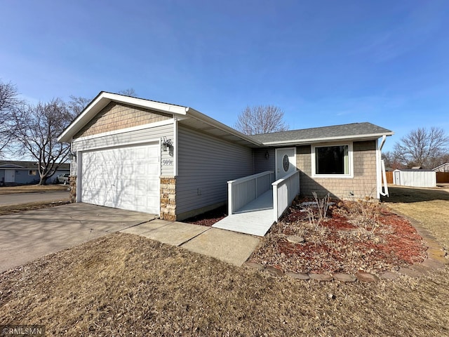 single story home with concrete driveway and an attached garage