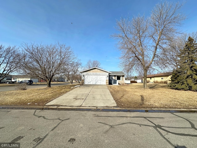 view of front of property featuring an attached garage and concrete driveway