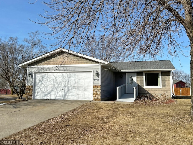 ranch-style home featuring concrete driveway, an attached garage, and roof with shingles