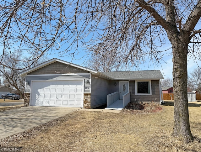 single story home featuring a garage, roof with shingles, and concrete driveway