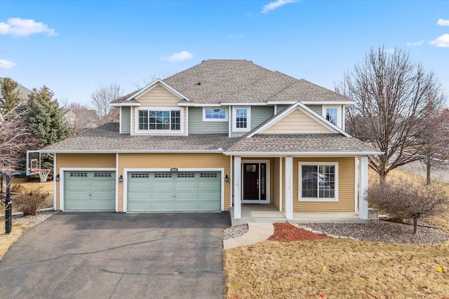 view of front of property featuring driveway and roof with shingles