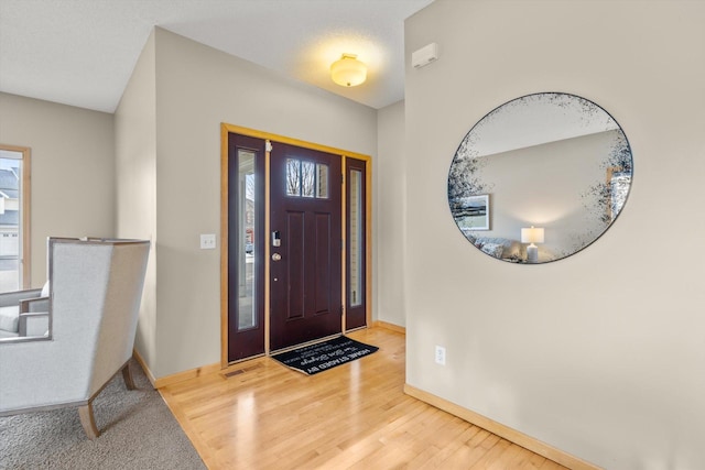 entrance foyer featuring wood finished floors and baseboards