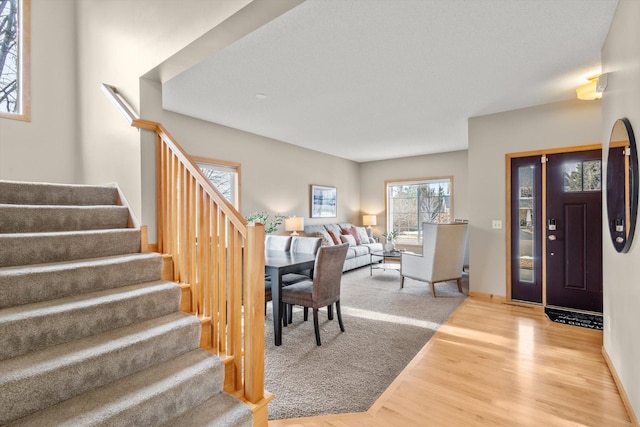 entryway featuring stairway and wood finished floors