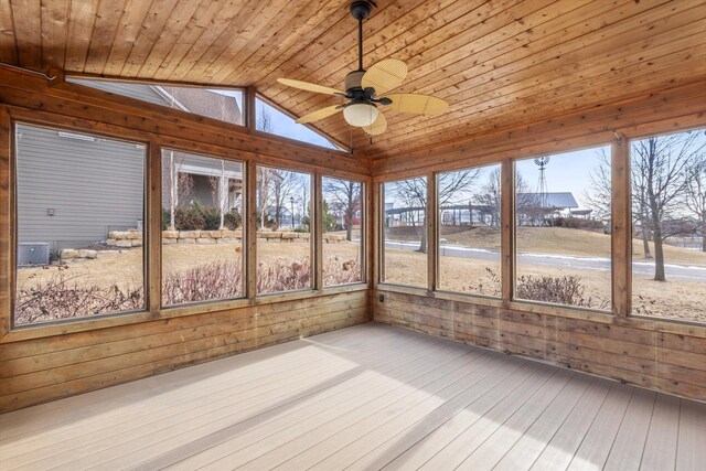 unfurnished sunroom featuring a ceiling fan, vaulted ceiling, and wood ceiling