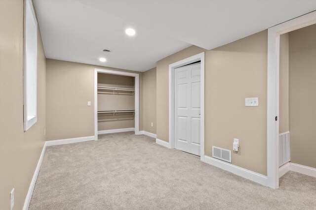 unfurnished bedroom with recessed lighting, visible vents, carpet flooring, and baseboards