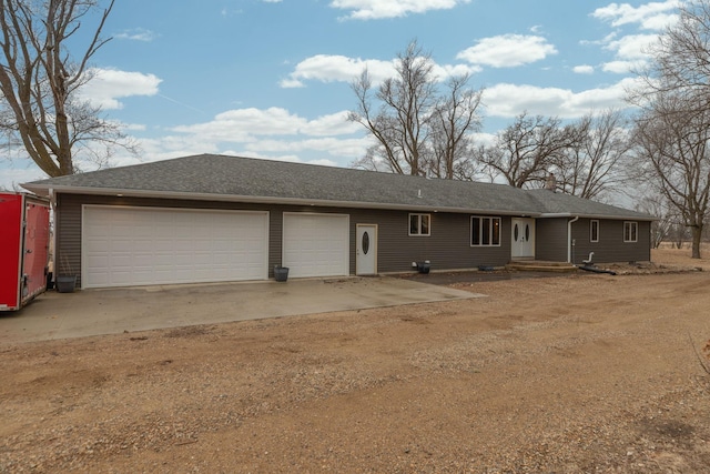 ranch-style home with driveway and an attached garage