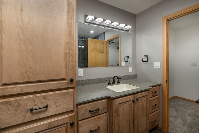 bathroom with vanity and baseboards