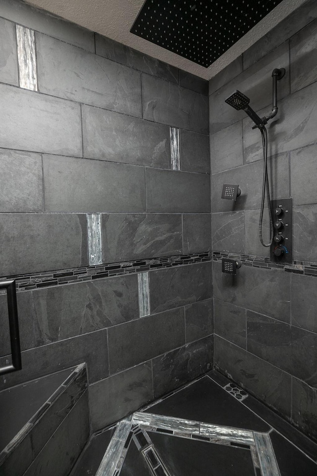 full bath featuring a tile shower