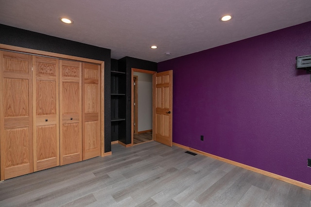 unfurnished bedroom with recessed lighting, baseboards, and light wood finished floors