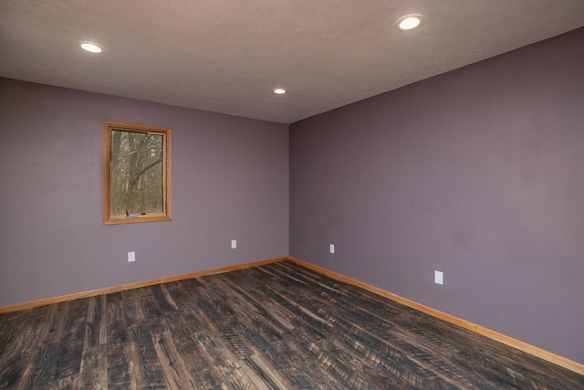 unfurnished room featuring dark wood-type flooring, recessed lighting, and baseboards