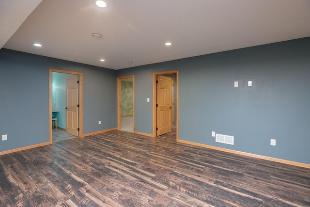 empty room featuring recessed lighting, visible vents, baseboards, and wood finished floors