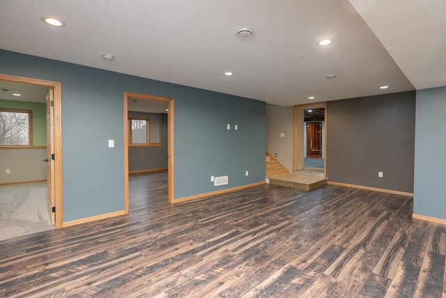 spare room with recessed lighting, baseboards, and wood finished floors