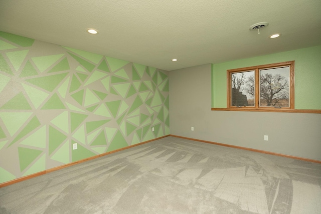 spare room featuring recessed lighting, visible vents, carpet flooring, a textured ceiling, and baseboards