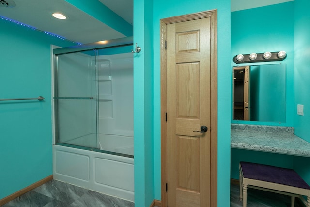 full bath with enclosed tub / shower combo, recessed lighting, vanity, and baseboards