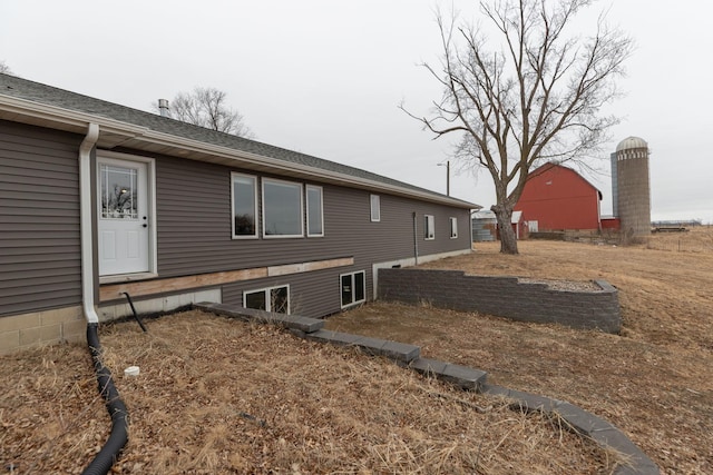 view of home's exterior featuring roof with shingles