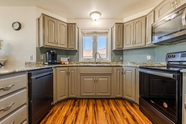 kitchen featuring electric range, dishwasher, dark wood-style floors, stainless steel microwave, and a sink