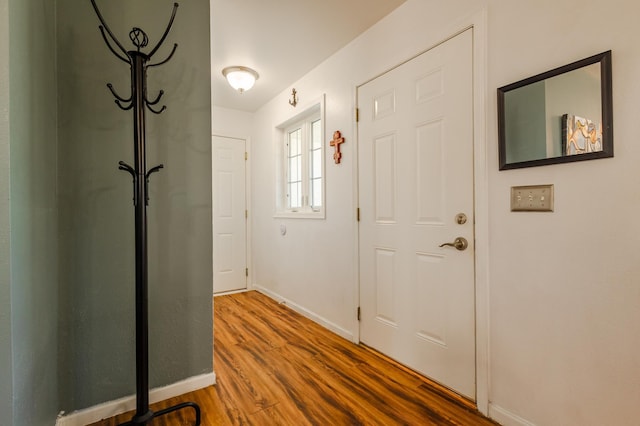 interior space with baseboards and wood finished floors