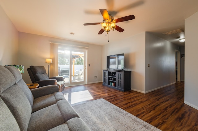 living room with a ceiling fan, dark wood-style flooring, visible vents, and baseboards