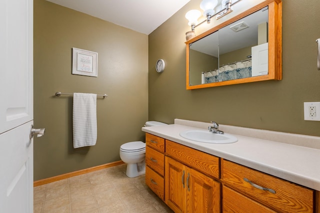 bathroom featuring visible vents, toilet, vanity, tile patterned flooring, and baseboards