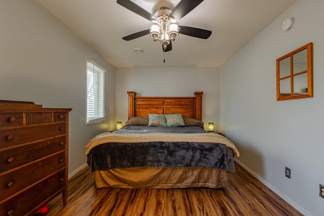 bedroom with wood finished floors, a ceiling fan, and baseboards