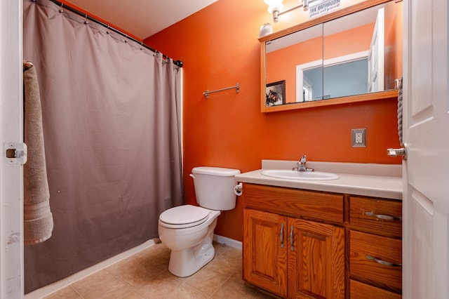 bathroom featuring a shower with shower curtain, vanity, toilet, and tile patterned floors