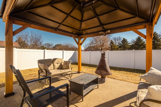 view of patio / terrace featuring a fenced backyard, an outdoor living space, and a gazebo