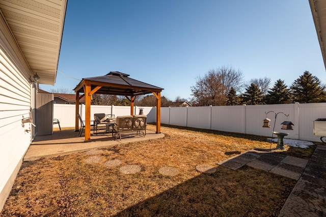 view of yard featuring a patio area, a fenced backyard, and a gazebo