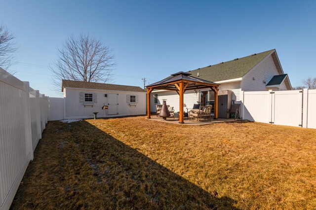 rear view of house with a fenced backyard, a lawn, a patio, and a gazebo