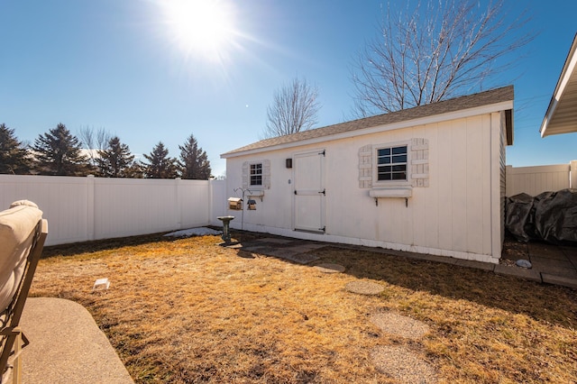 view of outdoor structure with a fenced backyard and an outdoor structure