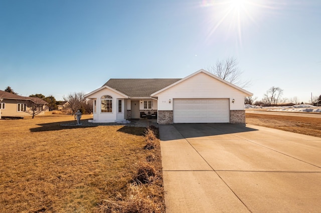 ranch-style home with driveway, brick siding, a front lawn, and an attached garage