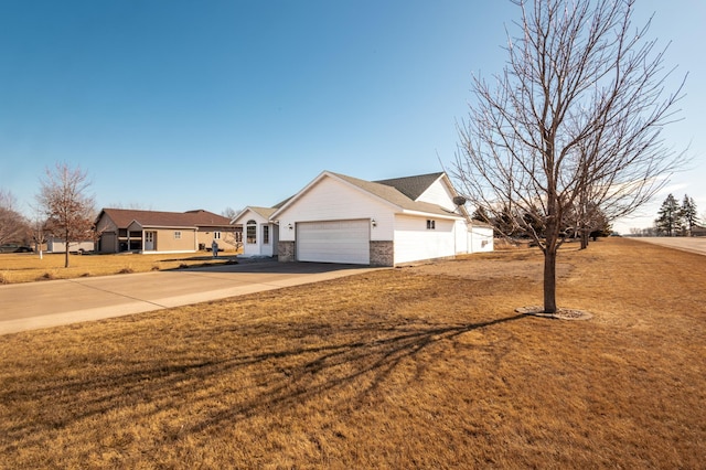 view of front of home with a garage, brick siding, driveway, and a front lawn