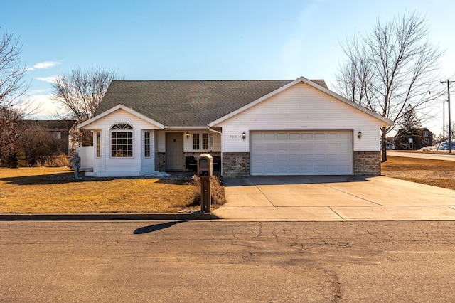 single story home featuring a garage, concrete driveway, brick siding, and roof with shingles