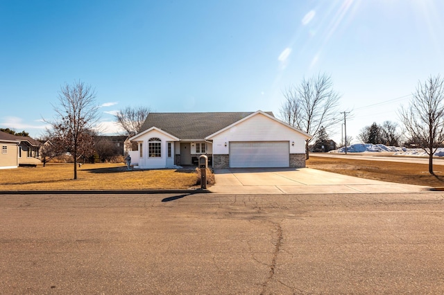 single story home with a garage, concrete driveway, and a front yard