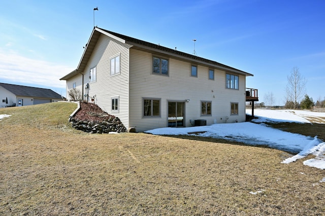 snow covered house featuring central AC