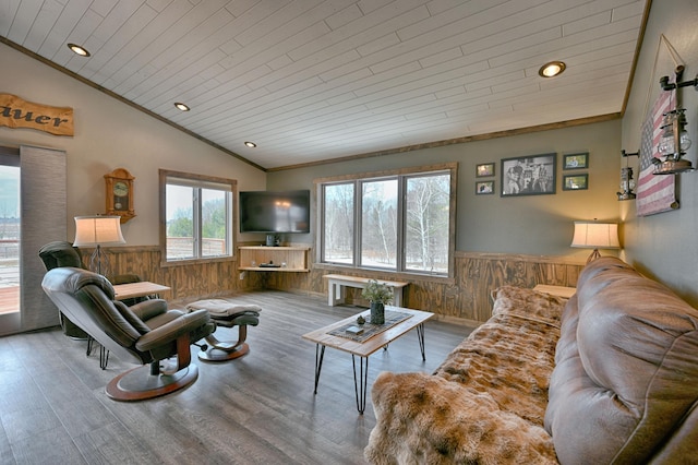 living room with lofted ceiling, a wainscoted wall, wooden walls, and wooden ceiling