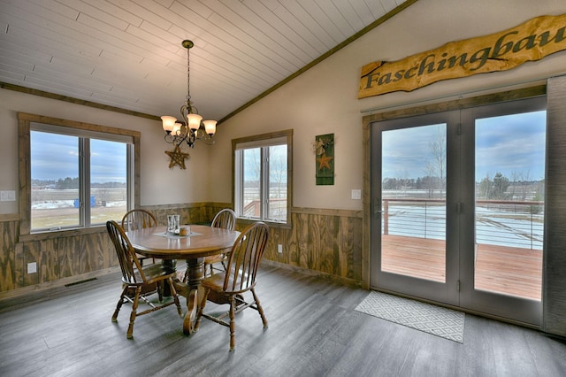 dining room with visible vents, lofted ceiling, a wainscoted wall, wood ceiling, and a chandelier