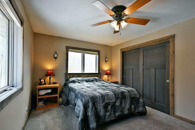 bedroom with ceiling fan, a closet, and carpet