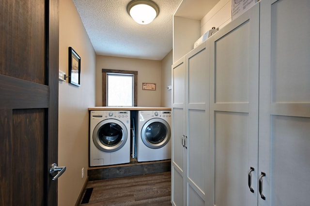 clothes washing area featuring a textured ceiling, washing machine and dryer, laundry area, visible vents, and dark wood-style floors