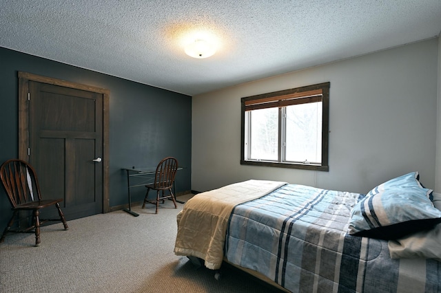 bedroom with light carpet and a textured ceiling