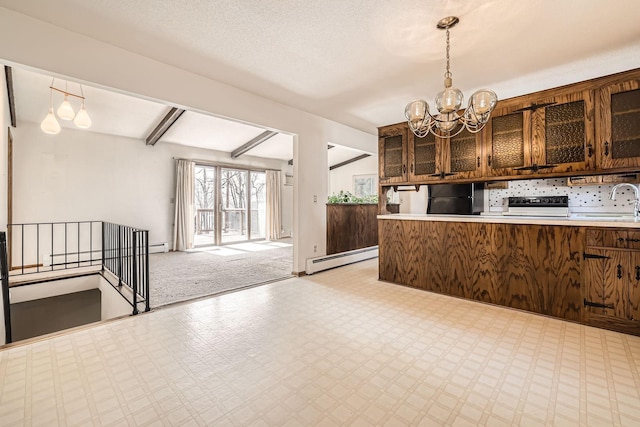 kitchen featuring light floors, a baseboard radiator, stove, black refrigerator, and open floor plan