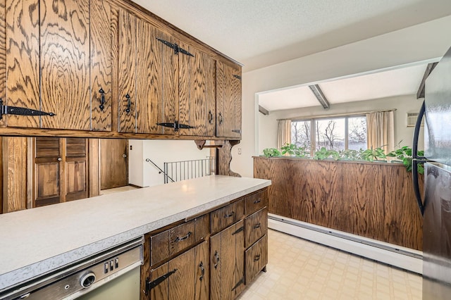 kitchen with light floors, beam ceiling, light countertops, dishwasher, and baseboard heating